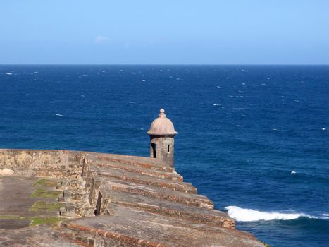 Looking Watchtower in San Juan, Puerto Rico on a clear day at shore edge of fort.