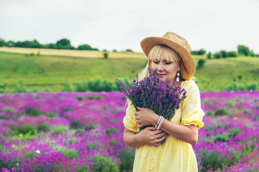 Beautiful woman in lavender field. Selective focus. Nature.