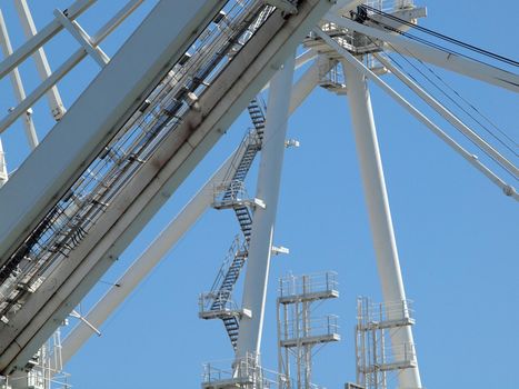 Close up of large shipping crane featuring stairs leading up to higher sections