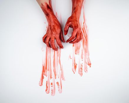 Female hands in blood on a white background