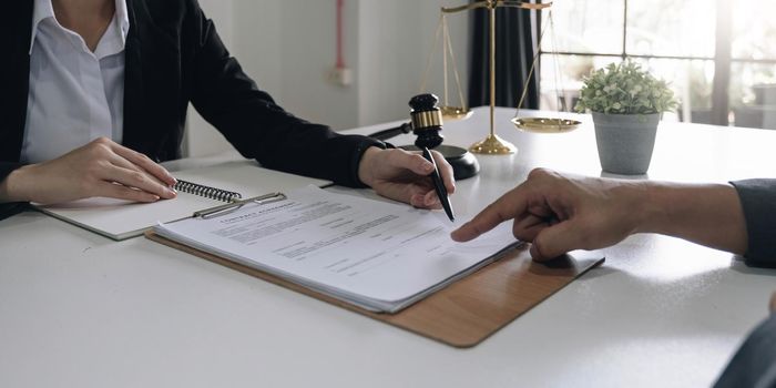 business people and lawyers discussing contract papers sitting at the table. Concepts of law, advice, legal services.