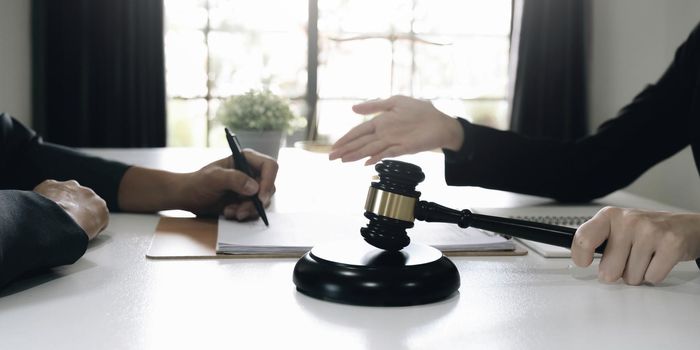 business people and lawyers discussing contract papers sitting at the table. Concepts of law, advice, legal services.