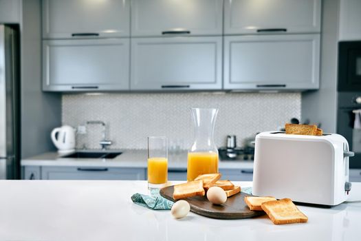 Continental breakfast - orange juice and toast on white table. Background with free text space.