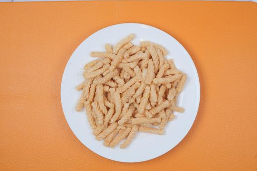 Processed pea nuts in a bowl on table top down