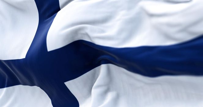 Close-up view of Finland national flag waving in the wind. Scandinavian country located in northern Europe