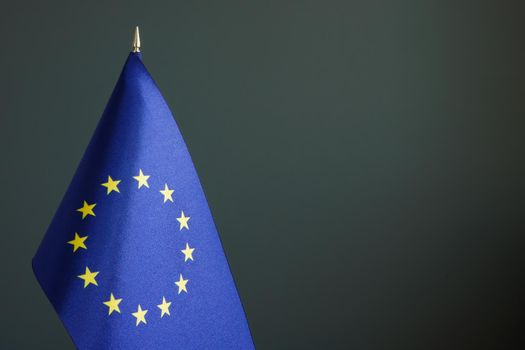 A Small EU flag and dark empty space.