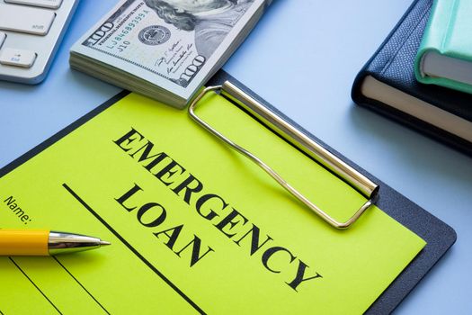 Emergency loan application with a clipboard and money.