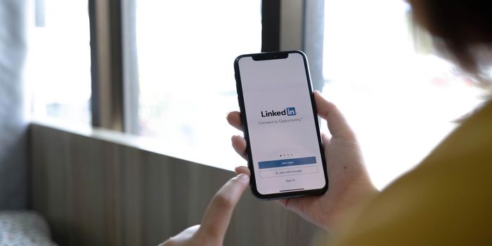 CHIANG MAI, THAILAND, JUL 12, 2022 : A women holds Apple iPhone Xs with LinkedIn application on the screen.LinkedIn is a photo-sharing app for smartphones..