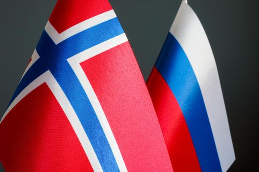 Closeup of the flags of Norway and Russia.