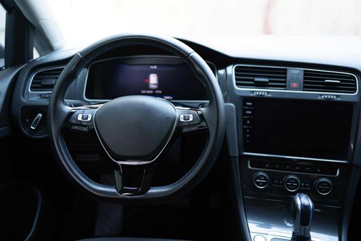 Empty cockpit electric vehicle, Head Up Display and digital speedometer. Steering wheel of electric vehicle, interior, cockpit, electric buttons. Autonomous car. Driverless car. Self-driving vehicle.