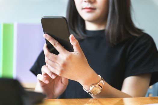 A business woman uses a cell phone to talk on the phone to a friend to chat between companies while at home