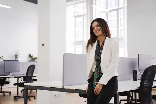 Confident caucasian professional woman achieving business success in modern office.