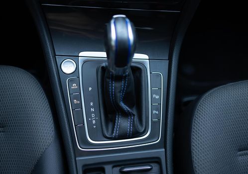 Handle of electric car gearbox control. Design details of minimalist concept of electric car - close-up details of automatic transmission and gear stick. Automatic gear lever and gear shift.