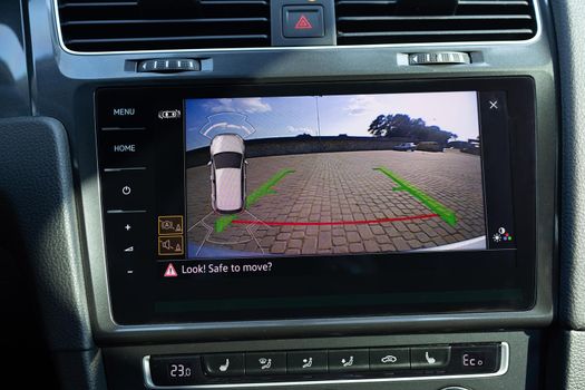 Rear View Monitor for car reverse system. Car display and rear view camera. Parking assistant inside car. Video parking system in modern car. Automotive safety technology equipment.