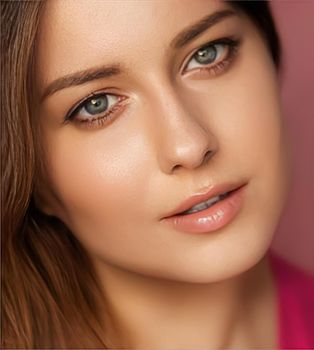 Beauty, makeup and skincare cosmetics model face portrait on pink background, beautiful woman with natural make-up, perfect healthy skin glow, facial care closeup