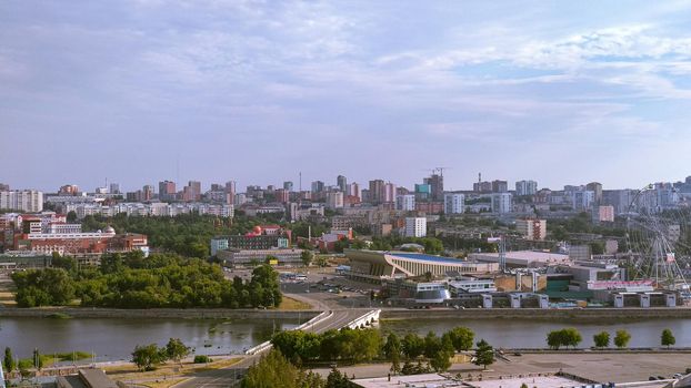 Panorama of a big city and storm clouds above it, river, general view