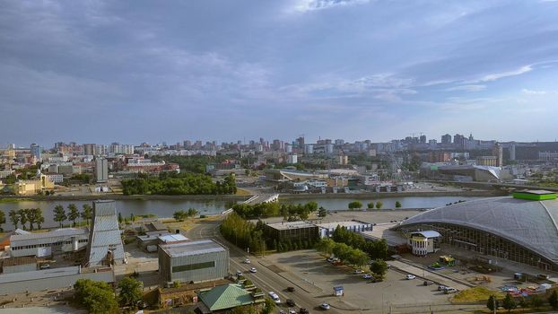 Panorama of a big city and storm clouds above it, river, general view