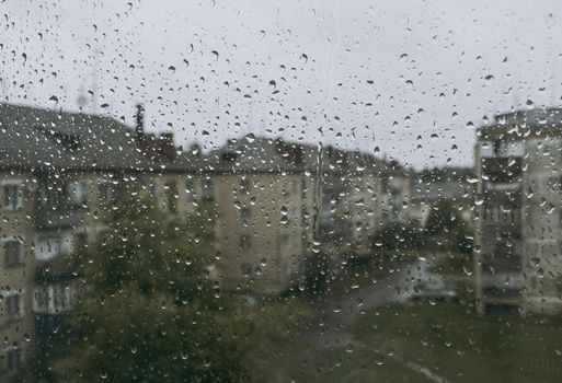 Raindrops on the window in cloudy summe