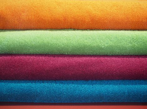 multicolored cotton towels including orange green red and blue useful as a background