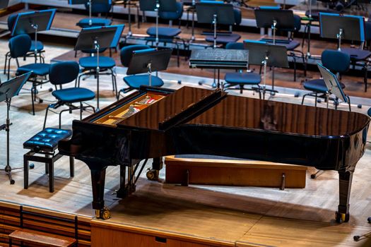 a piano on the Philharmonic stage among other musical instruments.