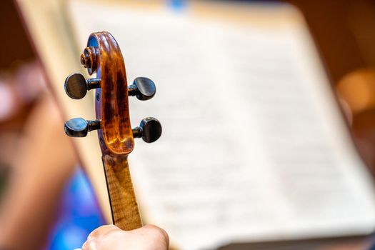 violin and sheet music at a concert in the Philharmonic.