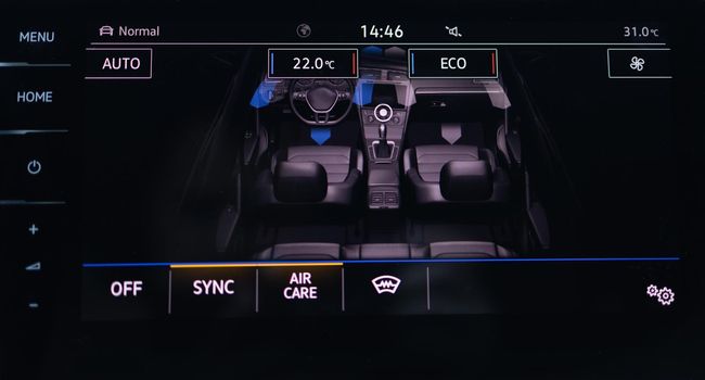 Modern car climate control display for driver and passenger. Zone climate control. Air conditioning buttons inside electric car. Climate control AC unit in the car. Car eco system mode inside interior