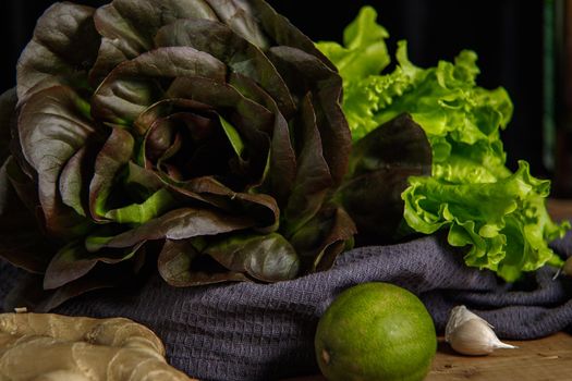 Bunch of fresh lettuce leaves on a dark background. Close-up.