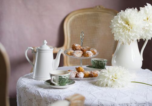 tea break in english style, vintage retro still life, homemade buns and a bouquet of white dalias. High quality photo