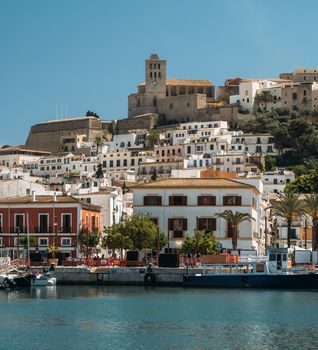 Port, old town and Castle of Ibiza. Sa Marina neighborhood and the historic complex of Dalt vila with blue sky and sea