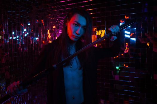 Male transgender neon light studio. Asian with samurai sword