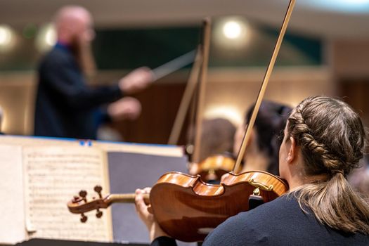 a violinist plays at a concert in the Philharmonic.