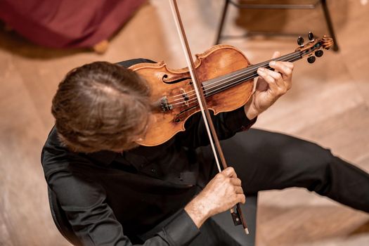 a violinist plays at a concert in the Philharmonic.