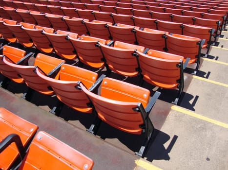 Rows of empty orange stadium seats. At Candlestick stadium in San Francisco.