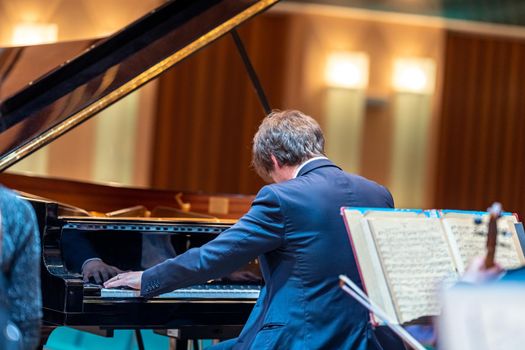 a piano on the Philharmonic stage among other musical instruments.