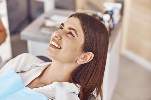 Happy caucasian woman in dental cabinet