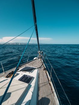 View from yacht prow heading in mediterranean sea with deep blue water in summer, Barcelona, Spain.