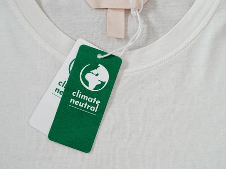 Carbon neutral t-shirt, Label Climate neutral on new clothes. Carbon neutral label concept in apparel, fashion industry. Ethical consumption.Increasing awareness for customers - carbon footpint