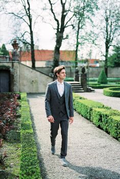 Man walks along a gravel path in the park. Lake Como, Italy. High quality photo