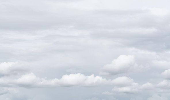 White cumulus clouds on gray sky texture background. Full frame of cloudscape background. Cloudy sky. Beauty in nature. White fluffy clouds. Nature weather. Soft texture like cotton of white clouds.