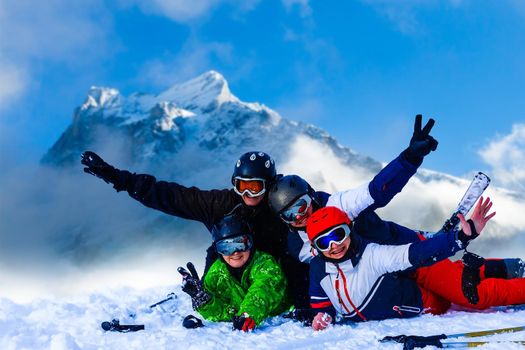 Smiling ski friends skiing alps resort.