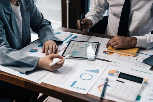 Asian business adviser meeting to analyze and discuss the situation on the financial report in the meeting room.Investment Consultant, Financial advisor and accounting concept.