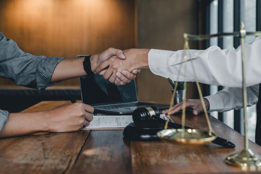 Business people shaking hands, finishing up a papers signing. Meeting, contract and lawyer consulting concept