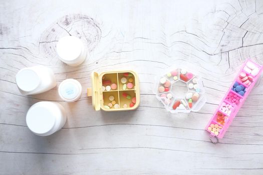 top view of medical pill box and container on table ,