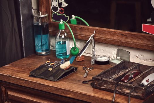 Barbershop tools on wooden brown table. Accessories for shaving and haircuts on the table. Still life