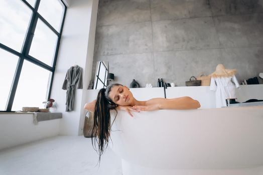 Happy woman bathing at home. Relaxation and wellness