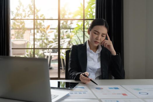 Portrait young business asian woman stressed displeased worried business woman sitting in front of laptop.