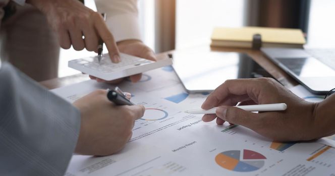 Business team brainstorming and discussing with financial data and report graph. Teamwork meeting working concept..