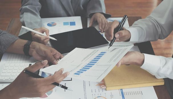 Asian business adviser meeting to analyze and discuss the situation on the financial report in the meeting room.Investment Consultant,Financial Consultant,Financial advisor and accounting concept.