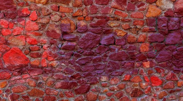 Abstract background of a multi-colored stone wall