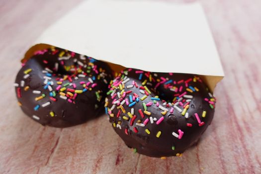 chocolate donuts on plate with copy space.